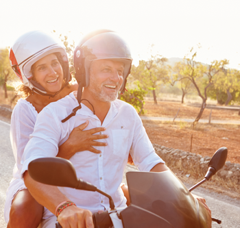 Man and woman riding on a moped